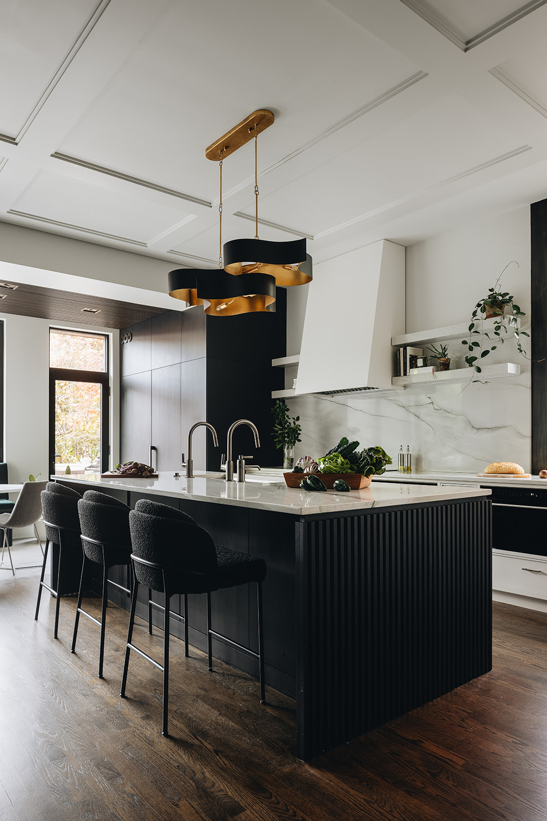 Sleek kitchen design featuring a spacious island and pendant lighting