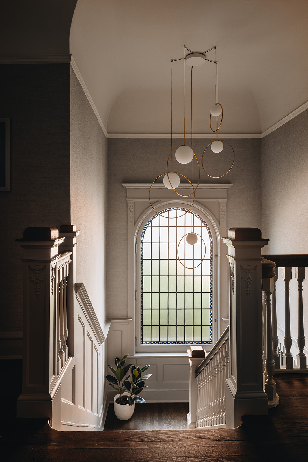 Grand stairwell featuring a sweeping staircase and ornate railing