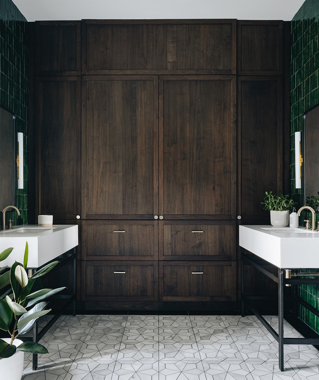 Large, dark brown cabinets with 2 bathroom sinks