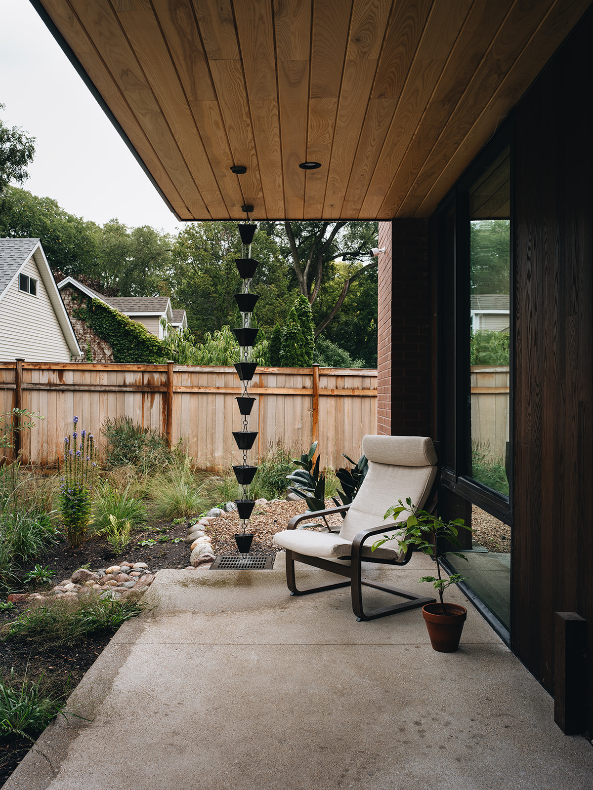 patio area with a modern chain gutter and a chair