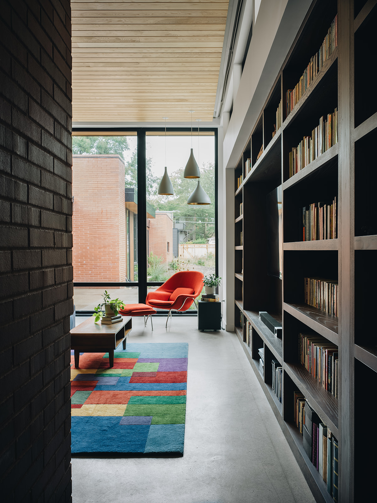 reading nook with large bookshelves and a large open window