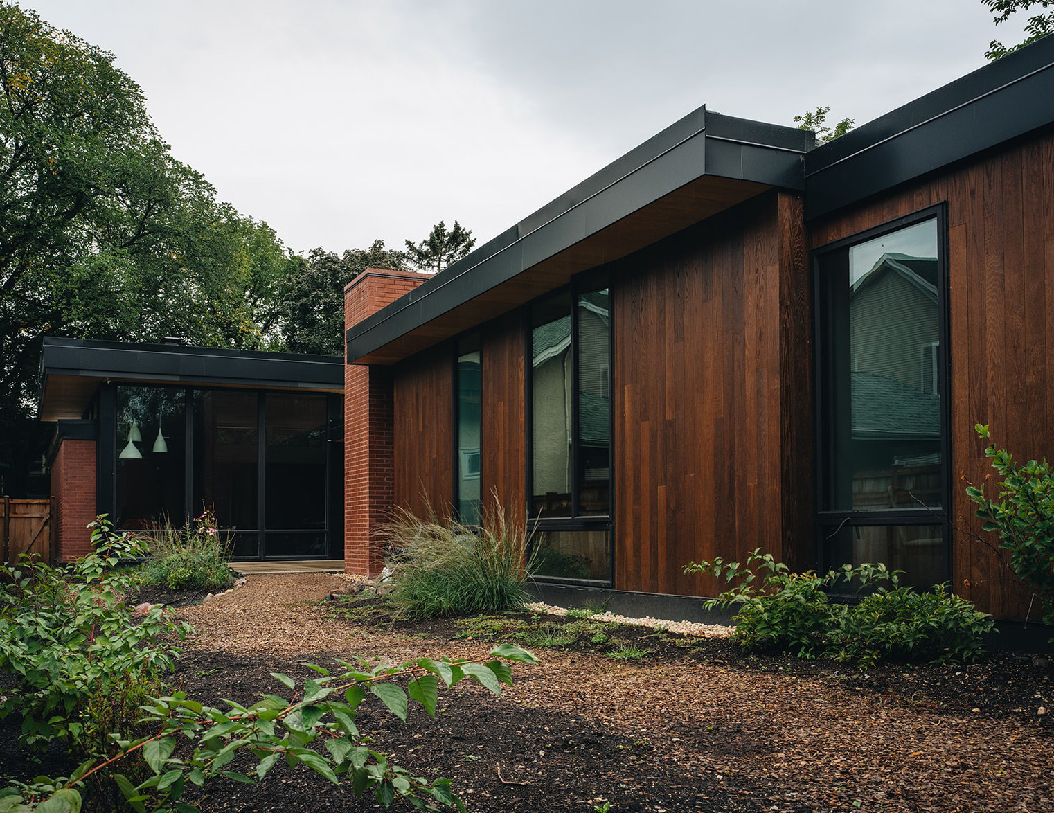 outdoor view of the back of the house, with large open-concept windows