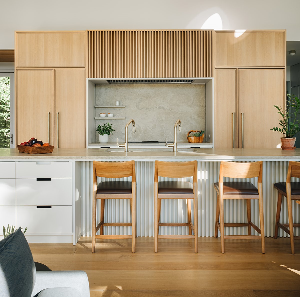 Modern kitchen with a sink in the island and large wooden cabinetry